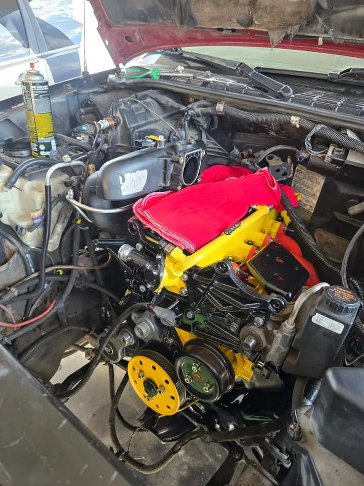 Hands working on a high-performance engine